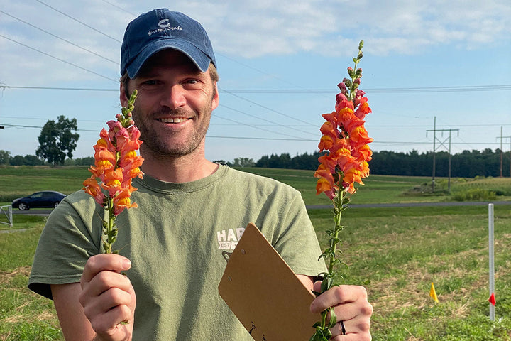 man holds cut flowers